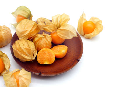 Indian gooseberry in a separate wooden plate on a white background.の写真素材