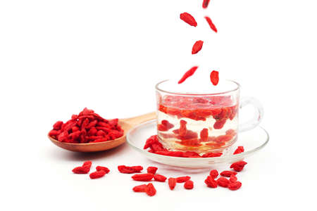 goji berries tea in a glass transparent cup on a white background isolatedの写真素材