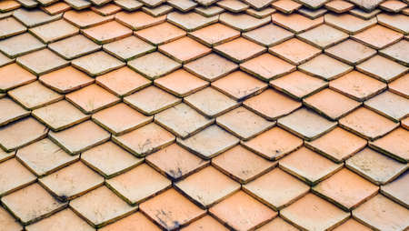 Pattern of Temple roof tile in thai style,
Ancient Thai roof, 
Orange tile fish scale pattern.の写真素材