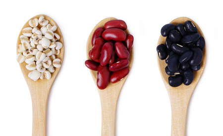 Isolated seed grains. Flat lay of arranged wooden spoons with various healthy seeds in mix on white background. Black beans, Red beans, seed millet.の写真素材