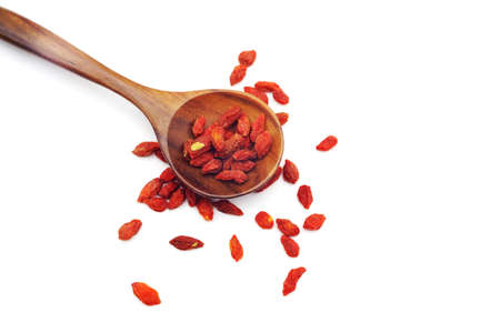 Chinese goji berries close up in wood spoon on white background. Lycium barbarum.の写真素材