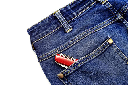 Denim blue jeans fabric with multitool. Ripped denim blue cloth background, text place, copy space. Destroyed torn denim blue jeans texture. Recycle old jeans denim conceptの写真素材