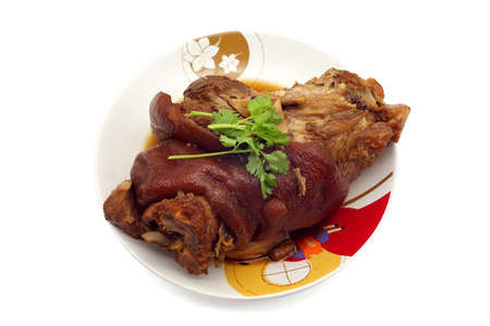 Traditional Bavarian schweinshaxe with coleslaw and preztel as closeup on a white background. traditional lunch dinner meal.の写真素材