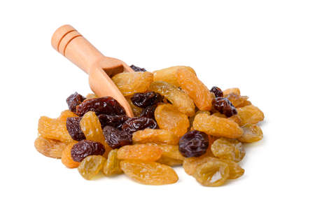 Isolated dried grapes. yellow or black is the highest grade with scoop on white background. with cliping path.の写真素材