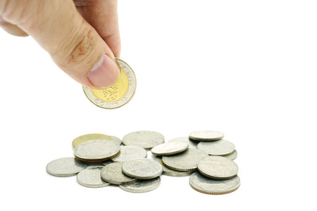 hand hold a coin isolated white background. Concept Business and financial saving.