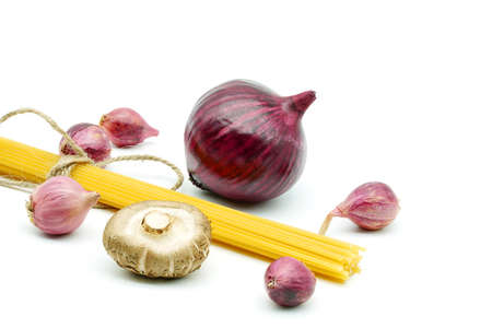 Cooking Italian Spaghetti Pastawith tomato and onion and mushroom. Raw materials for cooking isolated on a white background.の写真素材