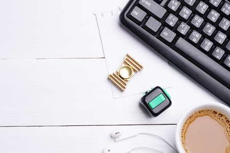 Flat lay, top view office white table wooden desk. Workspace with blank keyboard, notebook,  fidget...