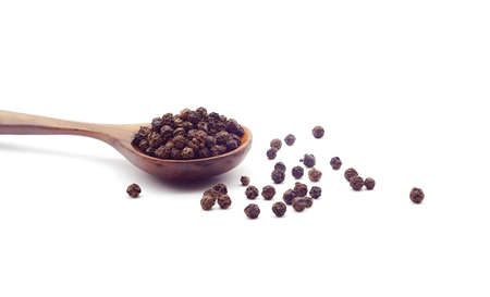 Dry heap black pepper isolated on white background with wooden spoon.
