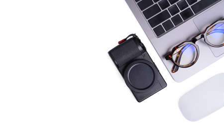 Flat lay laptop computer with camera are on top of white office desk table with eye glasses, mouse...