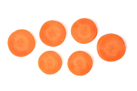 Isolated fresh carrot. Top view Carrot slice round shape on white background. Flat lay with clipping path.の写真素材