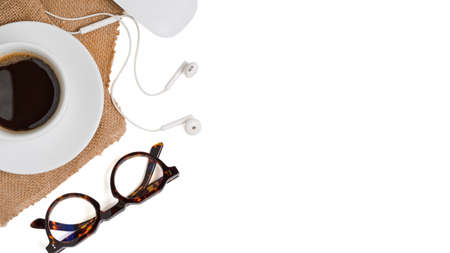 Flat lay laptop computer with camera are on top of white office desk table with eye glasses, mouse and supplies. Top view with copy spaceの写真素材