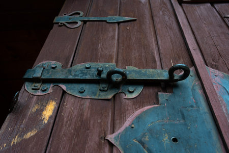 Old iron bolt on the wooden door