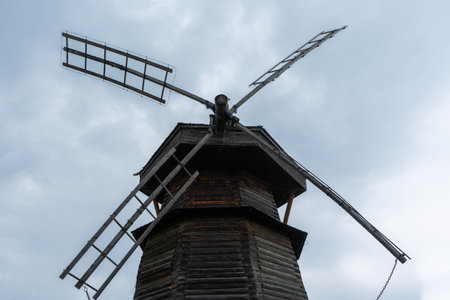 Old wooden grain mill against the skyの写真素材