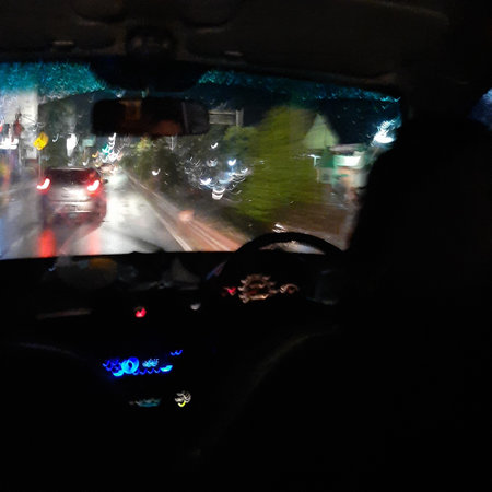 Driving in the rain. View from inside the car. Blurred motion