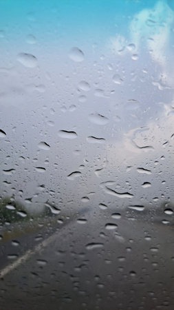 Rain drops on the car window in rainy day. Shallow DOFの写真素材