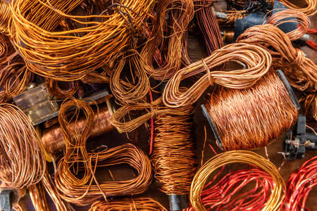 Closeup of copper waste in the form of copper wires, coils and transformers in landfill.