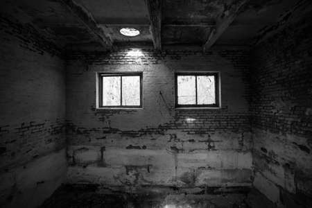 Empty interior of an abandoned square brick building in the afternoon.の写真素材
