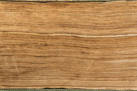 Textured stack of old closed book pages. Close up of old paper pages stack.