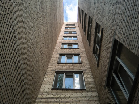 Bottom-up view of a multi-storey Soviet apartment building, an old abandoned house in a poor...