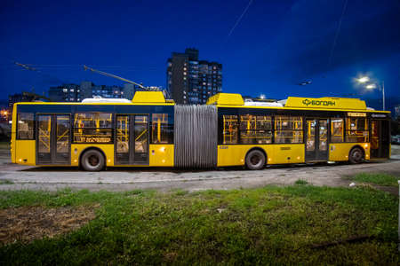 Kyiv, Ukraine - June 2, 2020: Yellow trolleybus on the streets of Kyiv in the residential area of Troieschyna at night. Trolleybus "Bogdan".のeditorial素材