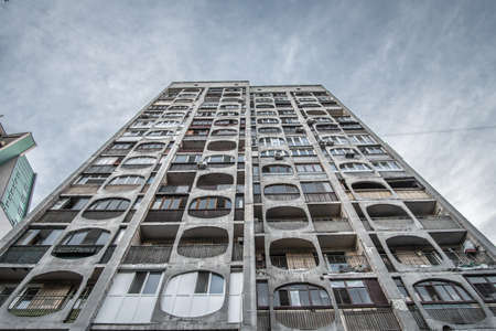 Bottom-up view of an old dirty residential multi-storey prefabricated concrete house in the style of brutalism in Eastern Europe.のeditorial素材