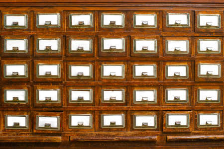 Textured wooden vintage file cabinets with empty spaces for text.