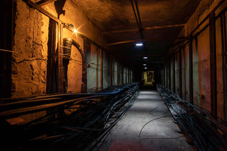 Underground cable tunnel with a cable coupling in the foreground. Underground tunnel with optical...
