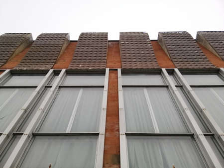 Urban Geometry, underside view to red steel old building. A fragment of the exterior of the building...