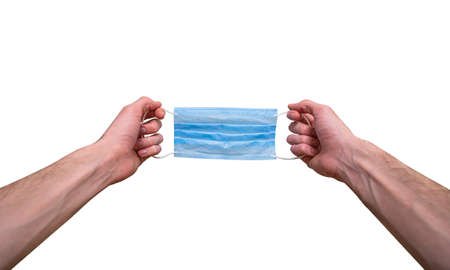 The young man's hands are wearing a medical mask, first-person view.