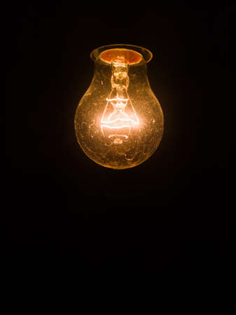 Tungsten incandescent lamp isolated on black background.の写真素材