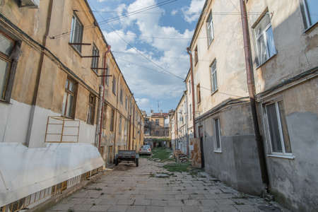 The old courtyard between the houses of the 19th century in Odessa in the afternoon. Odessa, Ukraine - August 2021.のeditorial素材
