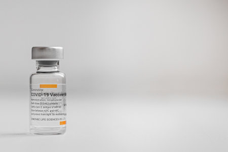 Ampoule with Covidvirus vaccine Covid 19 CoronaVac with free space for text on the right. Kyiv, Ukraine - June, 2021.のeditorial素材
