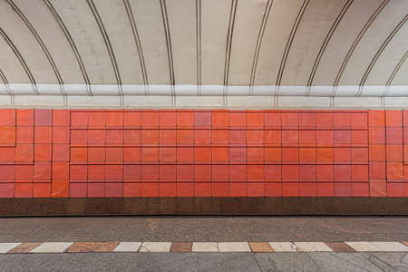 Old track wall at the metro station, lined with shabby red glazed ceramic tiles.の写真素材