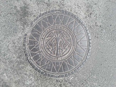 Old soviet hatchway of underground utilities with the inscription Telephone. NKS (People's Commissariat of Communications). Kharkiv, Ukraine - June 2021.のeditorial素材