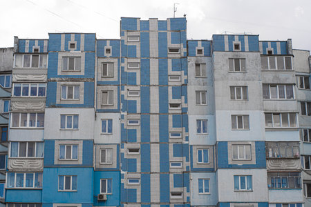 Facade of a panel apartment building of a Soviet house lined with blue tiles.の写真素材