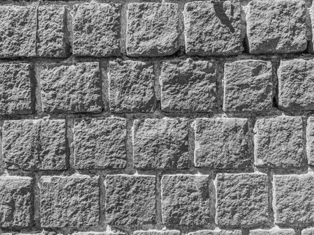Wall texture of gray stone blocks in daylight.の写真素材