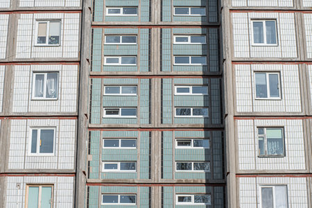 Architectural texture - multi-storey concrete panel apartment building lined with white tiles.