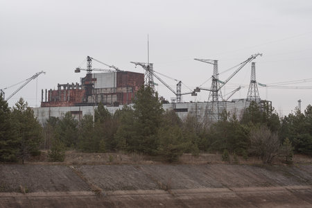 The 5th Unit of the Chernobyl Nuclear Power Plant is unfinished with silhouettes of construction cranes. Pripyat, Ukraine - November 28, 2021.のeditorial素材