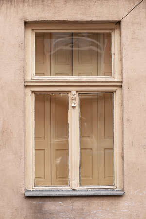 Old pastel wooden window in a 19th century house.
