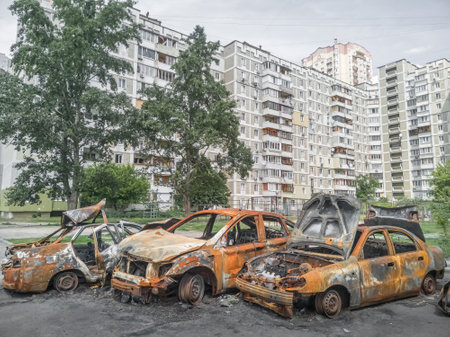 Burnt civilian cars of a residential area of %u200B%u200BKyiv.  Troyeshchyna, Kyiv, Ukraine - June 4, 2022.のeditorial素材
