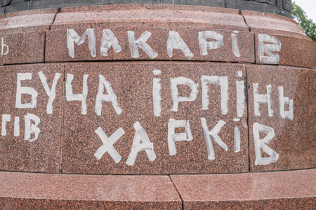 A granite pedestal with the inscriptions Makariv, Bucha, Irpin, Kharkiv - Ukrainian cities that suffered from Russian bombings. Pereyaslav, Kyiv region, Ukraine - July 13, 2022.のeditorial素材