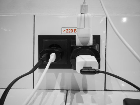 The black ac power sockets in the cafe is occupied by charging devices of Ukrainians who charge...