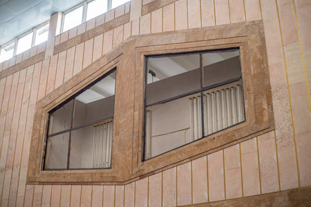 Architectural detail of a modern building with wooden windows and shutters