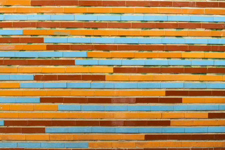 The wall is lined with a multi-colored pattern of oblong ceramic tiles in brown, orange, and blue colors.の写真素材