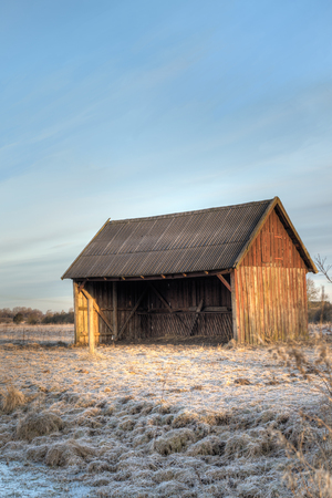 Farm animal shelter on a meadowの写真素材