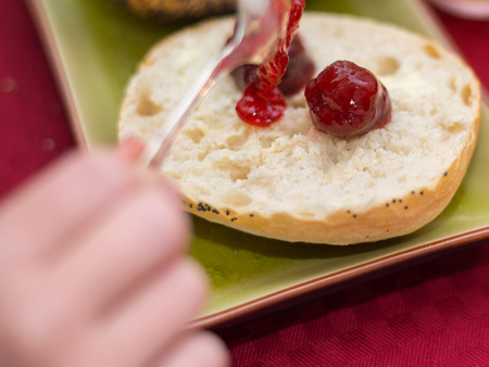 Closeup jam on a spoon on breadの写真素材