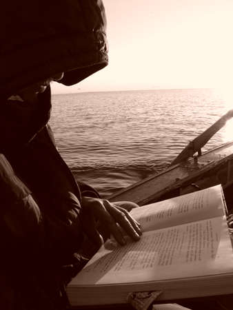 prayer in a boat on the riverの写真素材