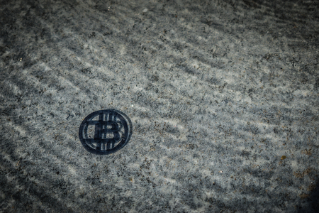 Plastic bit coin in corner with stone background and under water.の写真素材