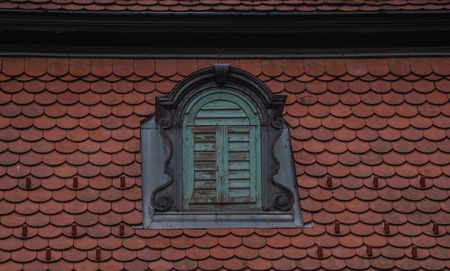 A crown window, old surrounded by tile in europeの写真素材