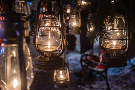 Oil lanterns hanging outside in winter snowed parkの写真素材